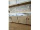 Close-up of the white kitchen cabinets and light grey tile backsplash at 17016 W Cavedale Dr, Surprise, AZ 85387