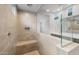 Walk-in shower features a tiled bench and niche for storage at 17767 W Getty Dr, Goodyear, AZ 85338