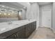 Bathroom featuring double sinks, granite countertops, and a large mirror for bright light at 17767 W Getty Dr, Goodyear, AZ 85338