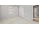 A bright, neutral bedroom features a window with blinds and a closet with sliding doors at 17767 W Getty Dr, Goodyear, AZ 85338