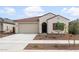 Charming single-story home featuring a red tile roof, stucco exterior, and a two-car garage at 17767 W Getty Dr, Goodyear, AZ 85338