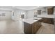 A modern, open-concept kitchen with a center island, stainless steel appliances, and a tile backsplash at 17767 W Getty Dr, Goodyear, AZ 85338