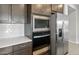 Gourmet kitchen with stainless steel appliances, granite countertops, and sleek dark cabinetry at 17767 W Getty Dr, Goodyear, AZ 85338