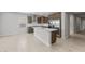 A modern, open-concept kitchen with a center island, stainless steel appliances, and tile flooring at 17767 W Getty Dr, Goodyear, AZ 85338