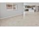 Open-concept living room with tile floors, lots of natural light, and view to the kitchen at 17767 W Getty Dr, Goodyear, AZ 85338