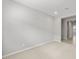 An open-concept living room features a neutral color palette and access to the hallway and other rooms at 17767 W Getty Dr, Goodyear, AZ 85338
