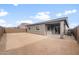 View of the backyard that features dirt and a covered patio at 17770 W Getty Dr, Goodyear, AZ 85338