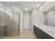 Modern bathroom featuring a glass-enclosed shower and double sink vanity at 17770 W Getty Dr, Goodyear, AZ 85338
