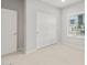 Bright bedroom with neutral carpet, a large window, and a closet with sliding doors provides ample space at 17770 W Getty Dr, Goodyear, AZ 85338