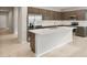 Modern kitchen boasts stainless steel appliances, a large island, and sleek brown cabinetry at 17770 W Getty Dr, Goodyear, AZ 85338