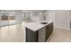 Kitchen island with sink and modern fixtures, seamlessly connecting to the living area at 17770 W Getty Dr, Goodyear, AZ 85338
