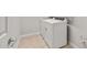 Bright laundry room features modern, white appliances, tiled flooring, and ample space for chores at 17770 W Getty Dr, Goodyear, AZ 85338
