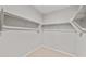 Empty walk-in closet with white walls and shelf and hanging system at 17770 W Getty Dr, Goodyear, AZ 85338