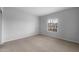 Bedroom with neutral walls, carpeted floor, baseboard trim, and window at 17779 W Getty Dr, Goodyear, AZ 85338
