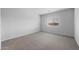 Bedroom with neutral walls, carpeted floor, baseboard trim, and window at 17779 W Getty Dr, Goodyear, AZ 85338
