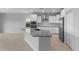 Bright, modern kitchen featuring white cabinets, stainless steel appliances, and a spacious island at 17779 W Getty Dr, Goodyear, AZ 85338