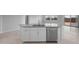 Modern kitchen island featuring sink, dishwasher, and ample storage space at 17779 W Getty Dr, Goodyear, AZ 85338