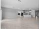 Bright open floor plan featuring neutral walls and floors that flow into a kitchen with stainless steel appliances at 17779 W Getty Dr, Goodyear, AZ 85338