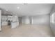 Bright open concept living space with modern kitchen island and tile floors at 17779 W Getty Dr, Goodyear, AZ 85338