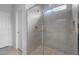 Bathroom with glass shower featuring a tiled enclosure and overhead window at 17779 W Getty Dr, Goodyear, AZ 85338