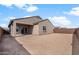 Spacious backyard with desert landscape, a covered patio and a privacy fence at 17791 W Getty Dr, Goodyear, AZ 85338