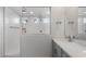 Luxury bathroom featuring a glass-enclosed shower, dual sinks, and modern fixtures and lighting at 17791 W Getty Dr, Goodyear, AZ 85338