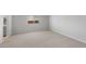 Spacious carpeted bedroom with view of bathroom vanity, offering ample space for relaxation and personalization at 17791 W Getty Dr, Goodyear, AZ 85338