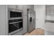 Close-up of modern kitchen appliances including built-in oven and microwave, and stainless steel refrigerator at 17791 W Getty Dr, Goodyear, AZ 85338