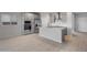 Open concept kitchen featuring stainless steel appliances, island, and tile flooring at 17791 W Getty Dr, Goodyear, AZ 85338