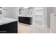 Stylish bathroom showcasing dark cabinets, white countertops, double vanity and a convenient walk-in closet at 18147 W Tanglewood Dr, Goodyear, AZ 85338