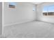 Bright bedroom featuring neutral walls and plush carpeting and a window to the backyard at 18147 W Tanglewood Dr, Goodyear, AZ 85338