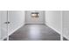 Empty bedroom showing wood floors, a window view, neutral walls, and white trim at 18147 W Tanglewood Dr, Goodyear, AZ 85338