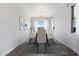 Cozy dining room with a glass table, six chairs, wood floors, and art decorations at 18147 W Tanglewood Dr, Goodyear, AZ 85338