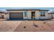 Inviting single-story home with gray garage door and low-maintenance desert landscaping at 18147 W Tanglewood Dr, Goodyear, AZ 85338