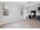 Open floor plan with wood-look tile and kitchen in the background at 18147 W Tanglewood Dr, Goodyear, AZ 85338