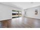 Living room with wood floors and sliding glass doors leading to an outdoor space at 18147 W Tanglewood Dr, Goodyear, AZ 85338