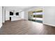 Open-concept living space with kitchen featuring an island and stainless steel appliances in background at 18147 W Tanglewood Dr, Goodyear, AZ 85338