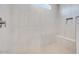 Modern shower with sleek tile, built-in bench, and convenient niche, creating a spa-like experience at 18147 W Tanglewood Dr, Goodyear, AZ 85338