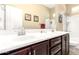 Bathroom features a double sink, shower and neutral paint at 18543 W Denton Ave, Litchfield Park, AZ 85340