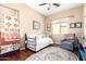 Charming bedroom with neutral walls, wood floors, daybed, and stylish decor at 18543 W Denton Ave, Litchfield Park, AZ 85340