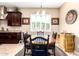 Cozy dining area with a wood table, black chairs, shuttered windows, and classic decor creating a welcoming atmosphere at 18543 W Denton Ave, Litchfield Park, AZ 85340