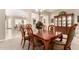 Elegant dining room featuring wood table and chairs, a chandelier, and a hutch with a view into the living room at 18543 W Denton Ave, Litchfield Park, AZ 85340