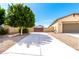 Extended driveway leading to a charming home with desert landscaping and a private gated entrance at 18543 W Denton Ave, Litchfield Park, AZ 85340