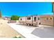 Spacious driveway with ample RV parking, connecting to a charming home with desert surroundings at 18543 W Denton Ave, Litchfield Park, AZ 85340