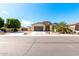 Charming single-story home with desert landscaping, a spacious driveway, and a welcoming front facade at 18543 W Denton Ave, Litchfield Park, AZ 85340
