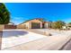 Attractive single-story home with a well-manicured lawn, desert landscaping, and spacious driveway at 18543 W Denton Ave, Litchfield Park, AZ 85340