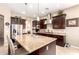 Spacious kitchen features granite counters, stainless appliances, and dark wood cabinets at 18543 W Denton Ave, Litchfield Park, AZ 85340