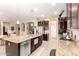 Modern kitchen with stainless steel appliances, granite countertops, dark wood cabinetry, and an open layout at 18543 W Denton Ave, Litchfield Park, AZ 85340