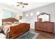 Cozy main bedroom showcasing hardwood floors, a large bed, and dresser with mirror at 18543 W Denton Ave, Litchfield Park, AZ 85340