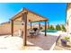 Inviting outdoor entertaining space with covered patio, built-in grill, and sparkling pool views at 18543 W Denton Ave, Litchfield Park, AZ 85340